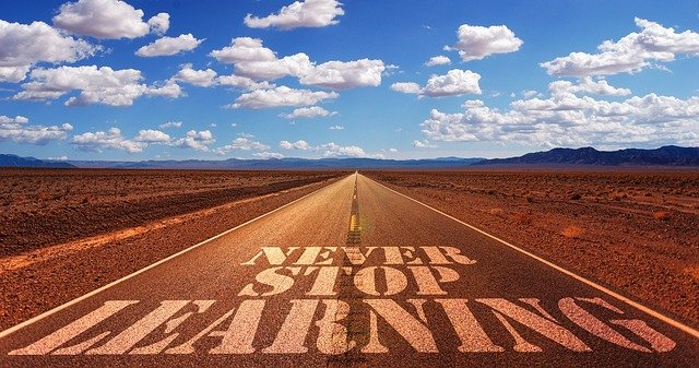 Image of A road leading to the horizon with the words 'Never Stop Learning' on it